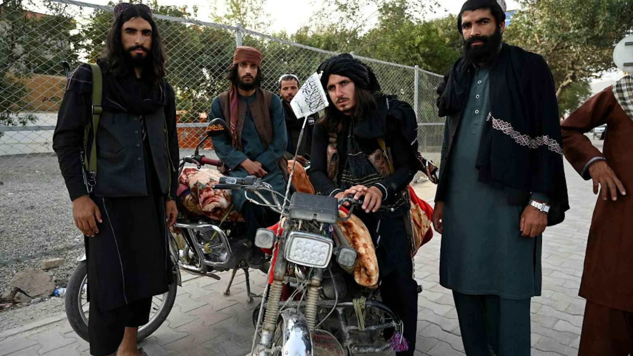 Taliban fighters stand along a road in Kabul on August 18, 2021, after the Taliban's military takeover of Afghanistan. (Photo by Wakil KOHSAR / AFP) (Photo by WAKIL KOHSAR/AFP via Getty Images)
