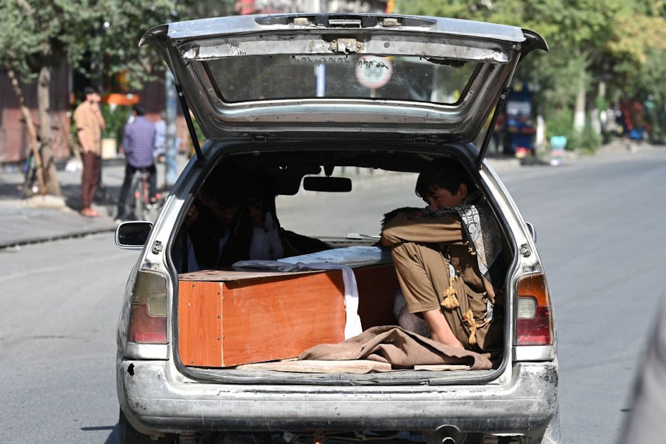Relatives transport in a car the coffin of a victim of the August 26 twin suicide bombs, which killed scores of people including 13 US troops outside Kabul airport, in Kabul on August 27, 2021. (Photo by Aamir QURESHI / AFP) (Photo by AAMIR QURESHI/AFP via Getty Images)