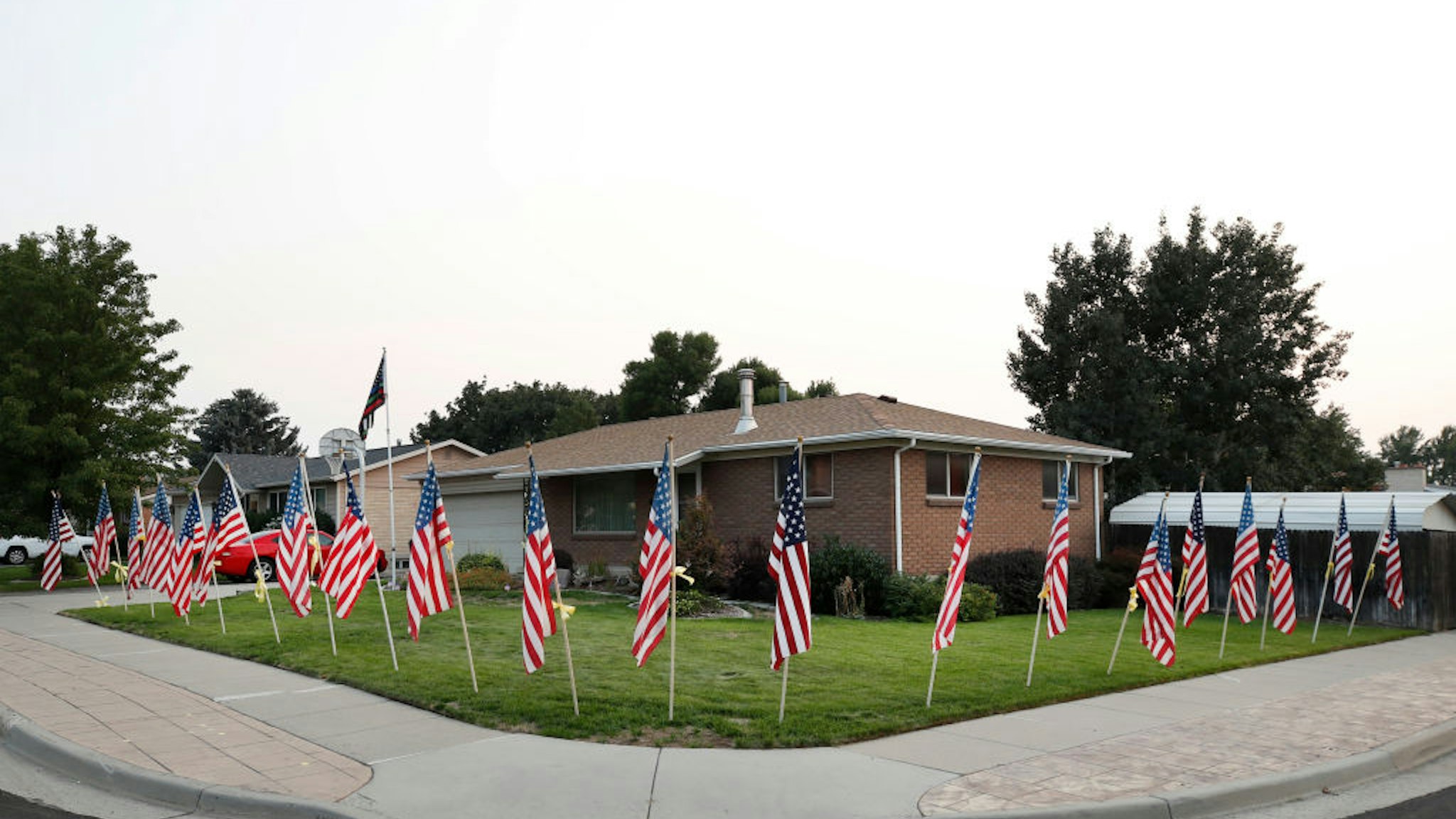 American flags and yellow ribbons line the sidewalk outside the house of Darren Hoover, whose son, Staff Sgt. Taylor Hoover was killed in Afghanistan, on August 27, 2021 in Sandy, Utah.