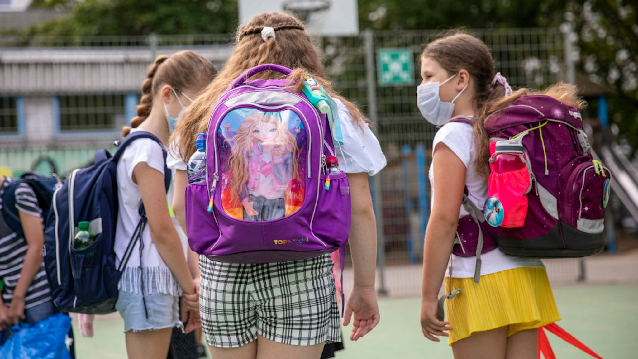 BERLIN, GERMANY - AUGUST 10: Children wearing protective face masks arrive for the first day of classes of the new school year at the GuthsMuths elementary school during the coronavirus pandemic on August 10, 2020 in Berlin, Germany. Classes at schools across Germany are beginning this month with face mask requirements varying by state. Coronavirus infection rates are climbing again in Germany, from an average of 400 new cases per day about two weeks ago to over 1,100 yesterday, according to the Robert Koch Institute. (Photo by Maja Hitij/Getty Images)