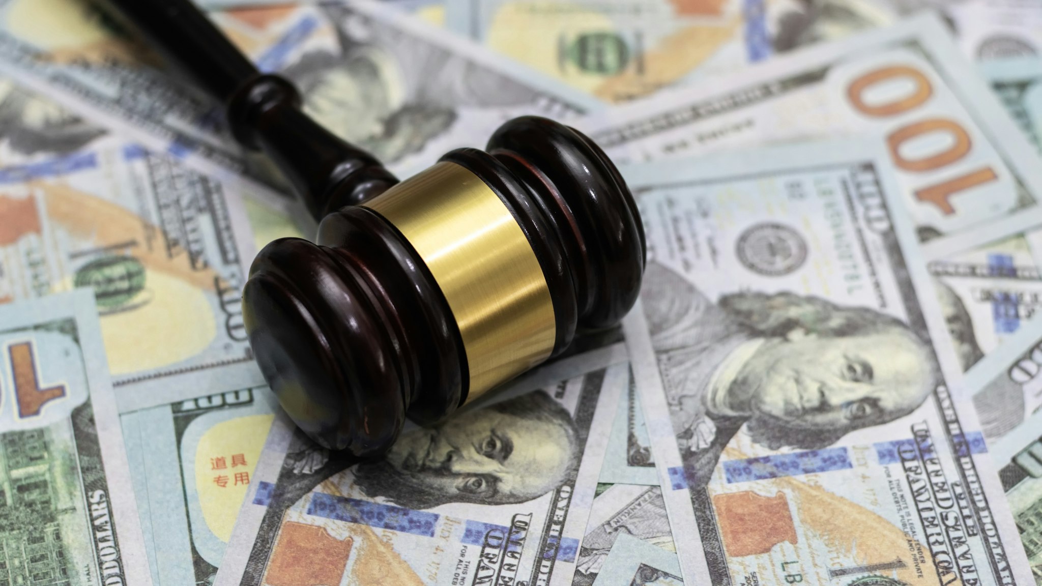 Money and hammer,Wooden gavel and dollar banknotes - stock photo