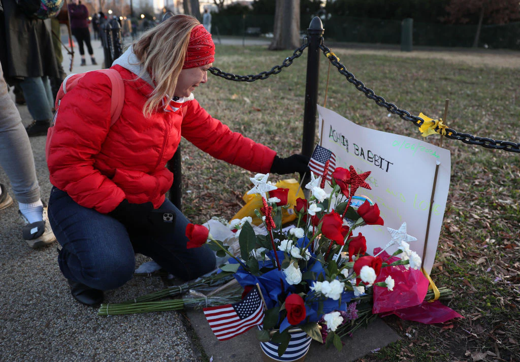 WASHINGTON, DC - JANUARY 07: Melody Black, from Minnesota, becomes emotional as she visits a memorial setup near the U.S. Capitol Building for Ashli Babbitt who was killed in the building after a pro-Trump mob broke in on January 07, 2021 in Washington, DC. Congress finished tallying the Electoral College votes and Joe Biden was certified as the winner of the 2020 presidential election. (Photo by Joe Raedle/Getty Images)