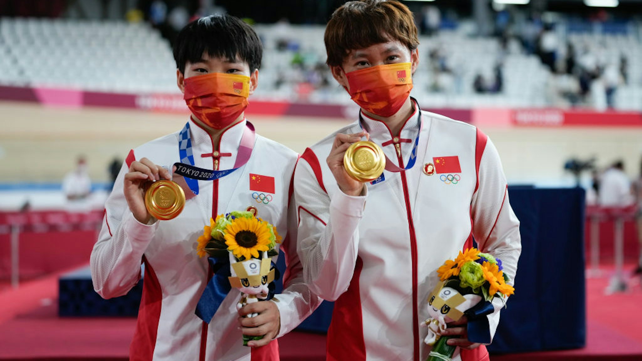 IZU, JAPAN - AUGUST 02: Gold medalists Zhong Tianshi and Bao Shanju of Team China pose during the medal ceremony for the Women's Team Sprint Finals of the Track Cycling on day ten of the Tokyo 2020 Olympic Games at Izu Velodrome on August 2, 2021 in Izu, Shizuoka, Japan. (Photo by Wei Zheng/CHINASPORTS/VCG via Getty Images)