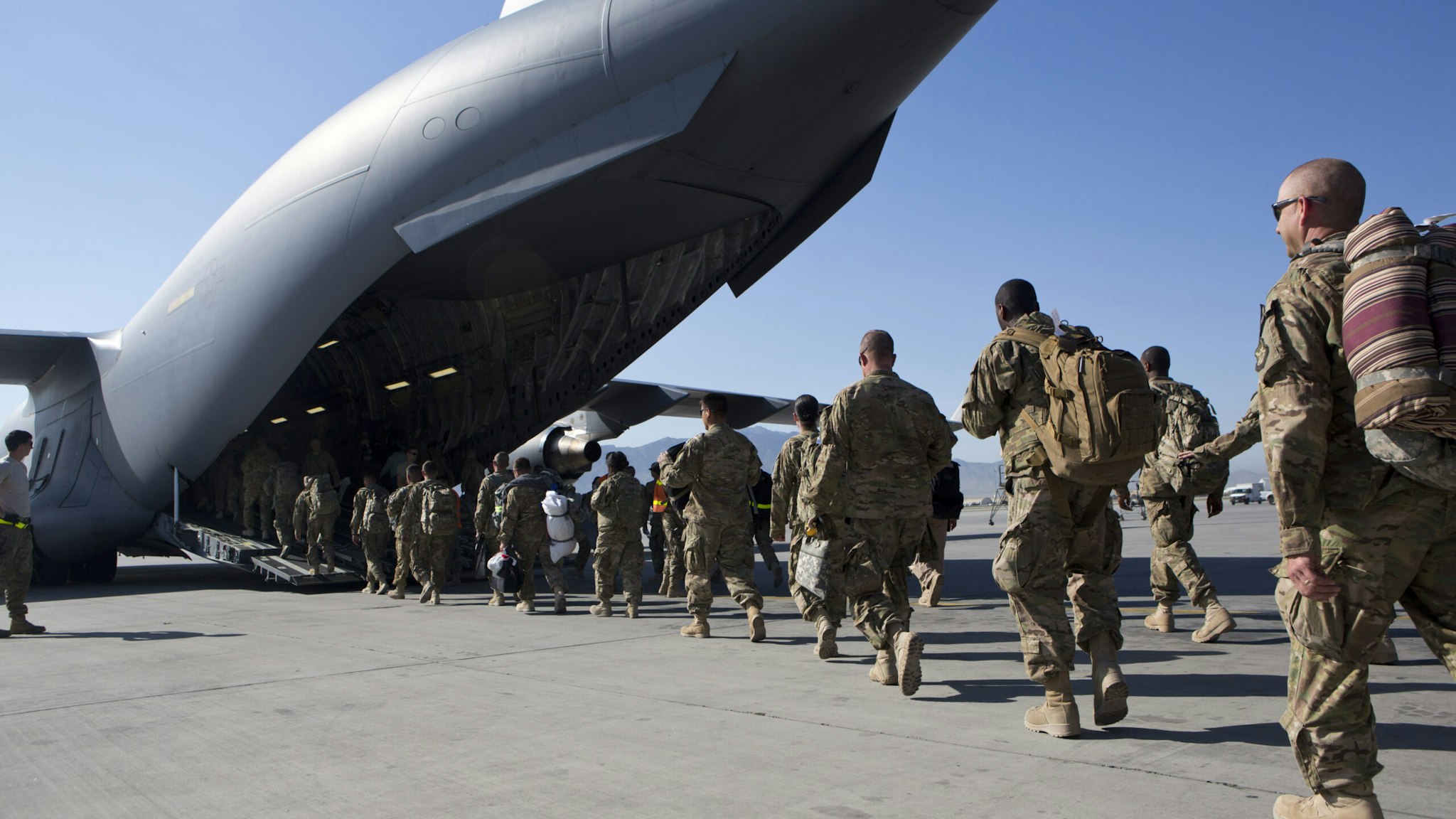 BAGRAM AIR BASE, AFGHANISTAN - MAY 11: U.S. Army soldiers walk to their C-17 cargo plane for departure May 11, 2013 at Bagram Air Base, Afghanistan. U.S. soldiers and marines are part of the NATO troop withdrawal from Afghanistan, to be completed by the end of 2014. (Photo by Robert Nickelsberg/Getty Images)