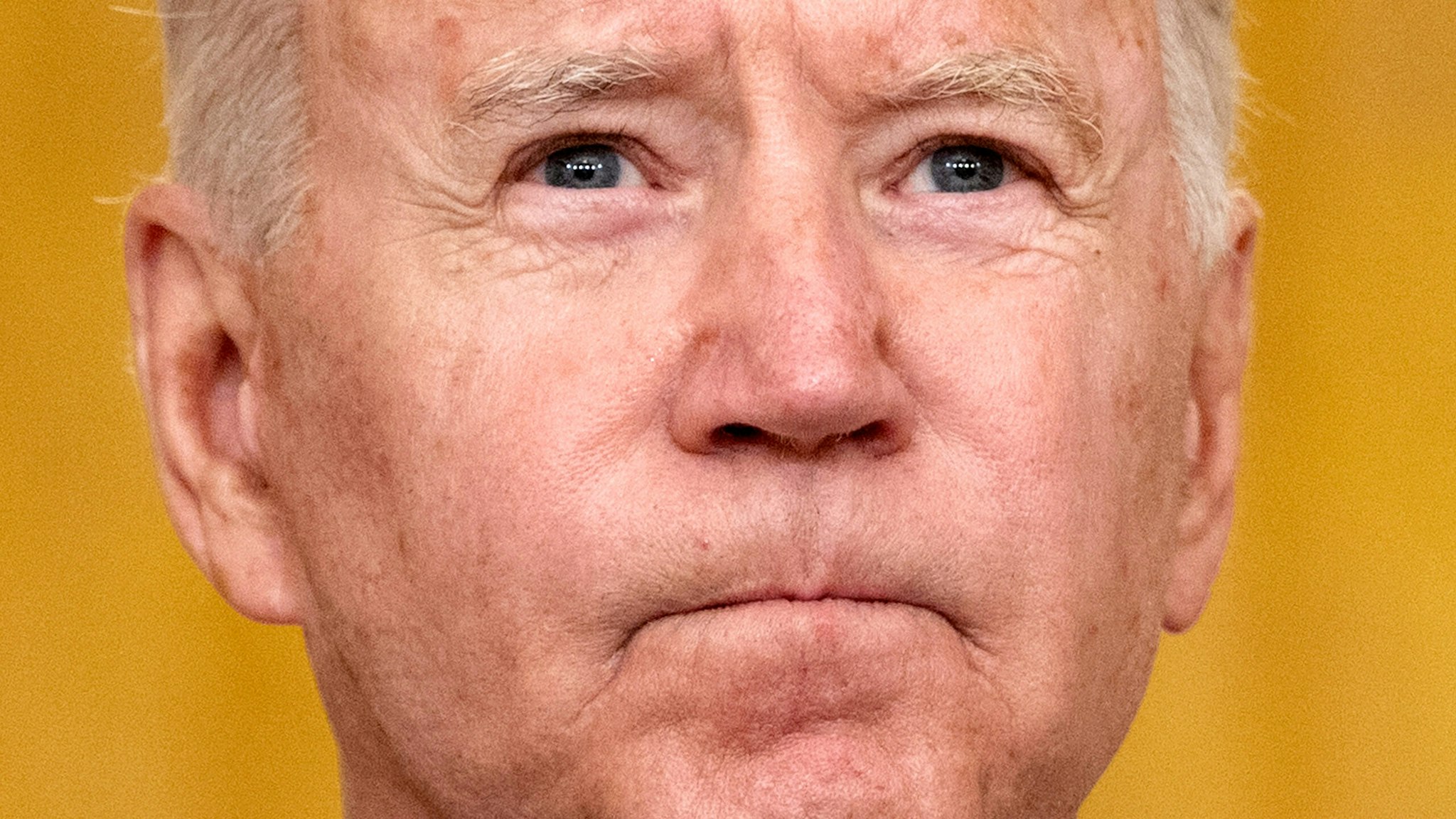 TOPSHOT - US President Joe Biden pauses as he delivers remarks on the terror attack at Hamid Karzai International Airport, and the US service members and Afghan victims killed and wounded, in the East Room of the White House, Washington, DC on August 26, 2021.