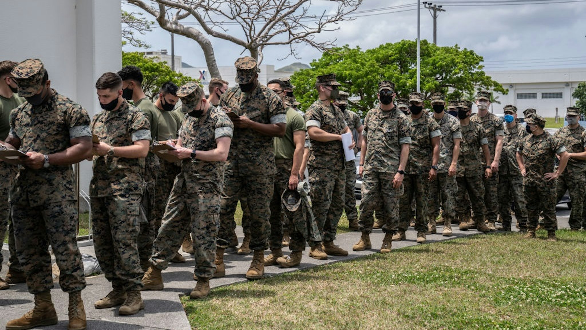 KIN, JAPAN - APRIL 28: United States Marines queue to receive the Moderna coronavirus vaccine at Camp Hansen on April 28, 2021 in Kin, Japan.