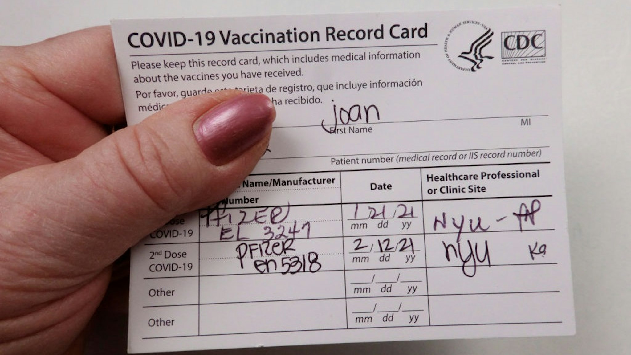 In this photo illustration, Patient holding Covid 19 vaccinated record card.