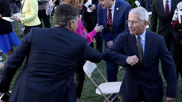 WASHINGTON, DC - MARCH 30: National Institute of Allergy and Infectious Diseases Director Anthony Fauci (L) bumps elbows with CNN correspondent Jim Acosta following the daily coronavirus briefing at the Rose Garden of the White House on March 30, 2020 in Washington, DC. The United States has updated its guidelines to U.S. citizens to maintain current social distancing practices through the end of April after the number of reported coronavirus (COVID-19) deaths doubled to over 2,000 nationwide within two days. (Photo by