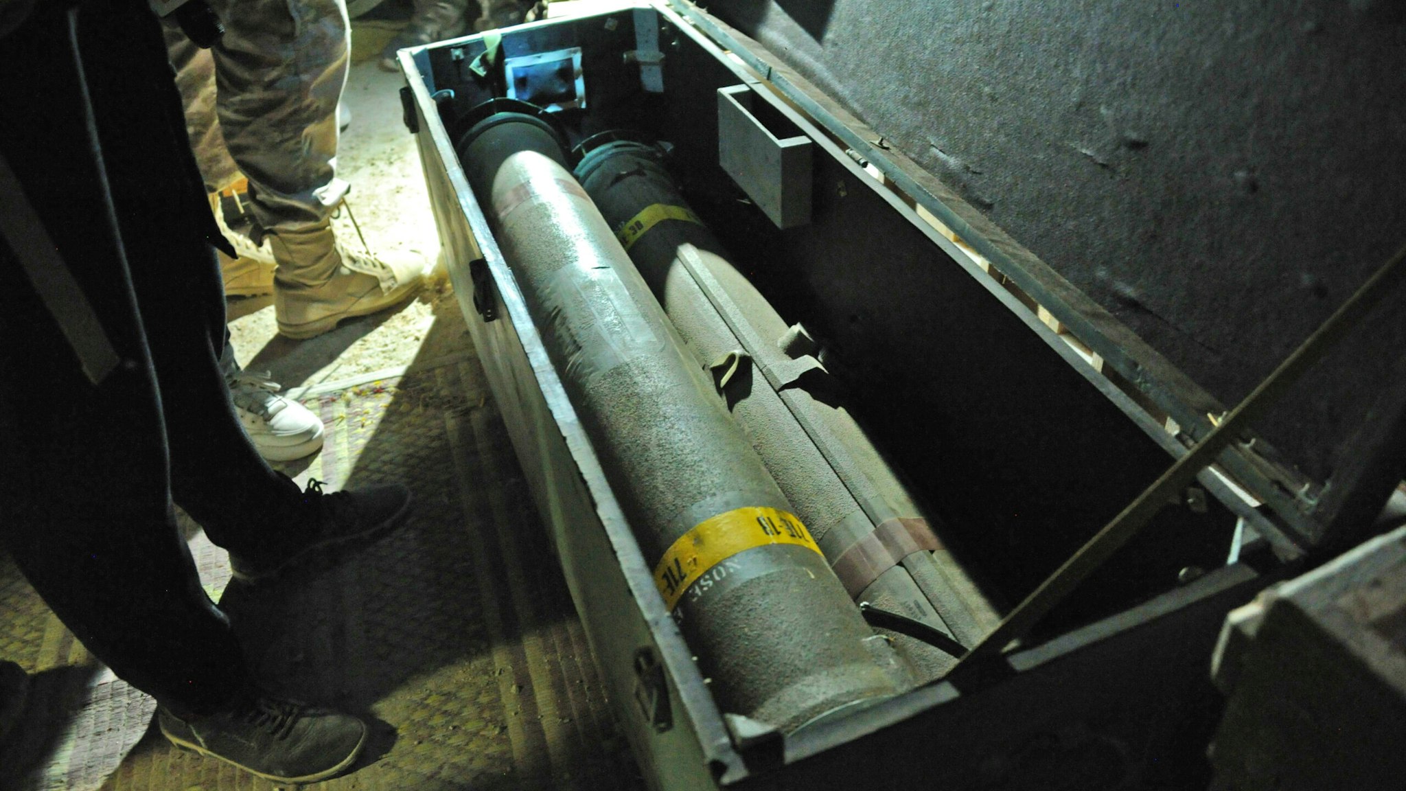 This picture taken on September 25, 2019 reportedly shows a crate of missiles in a weapons cache at a cave and tunnel system used by Syrian anti-government fighters near al-Lataminah in Hama province. - According to the Russian army, this vast underground network was used as a military base and habitation quarters by rebel fighters and as a workshop for making drones, and was abandoned as pro-government forces advanced on the area.