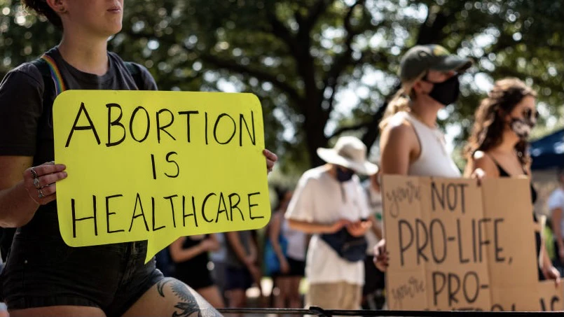 Texans Rally At State Capitol Against New Abortion Bill AUSTIN, TX - SEPTEMBER 11: A woman carries a sign declaring abortion a part of healthcare at a rally at the Texas State Capitol on September 11, 2021 in Austin, Texas. Texas Lawmakers recently passed several pieces of conservative legislation, including SB8, which prohibits abortions in Texas after a fetal heartbeat is detected on an ultrasound, usually between the fifth and sixth weeks of pregnancy. (Photo by Jordan Vonderhaar/Getty Images) Jordan Vonderhaar / Stringer