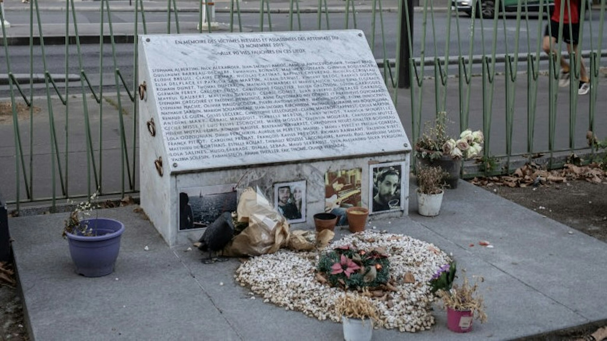 Trial To Begin For November 2015 Attacks, Which Killed 130 PARIS, FRANCE - SEPTEMBER 07: Pictures adorn the memorial plaque for the victims of the November 2015 terror attacks near the Bataclan Theatre and Cafe on September 7, 2021 in Paris, France. In November 2015, three teams of jihadists launched a suicide-bombing and gun assault on bars, restaurants and the Bataclan concert hall, killing 130. Tomorrow is the first day of what is scheduled to be a nine-month trial over these attacks, with 14 of 20 defendants present, including the sole surviving attacker. The Islamic State claimed responsibility for the attacks, which were allegedly planned from Syria. (Photo by Siegfried Modola/Getty Images) Siegfried Modola / Stringer via Getty Images
