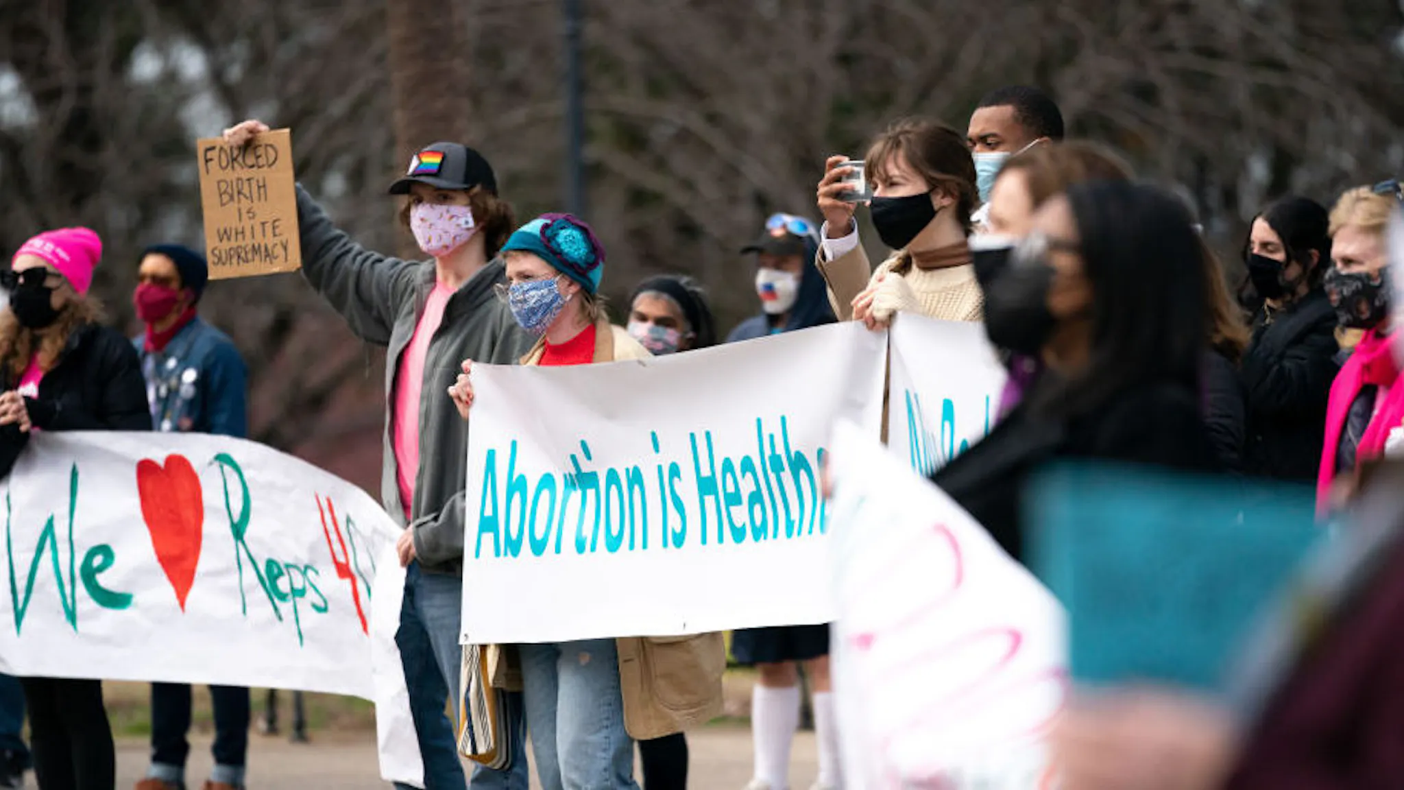 Demonstrators holding placards and banners expressing their COLUMBIA, SOUTH CAROLINA, UNITED STATES - 2021/02/17: Demonstrators holding placards and banners expressing their opinion, during a press conference and protest by Democrats who walked out during a debate on an anti-abortion bill in the House of Representatives. Republicans passed the bill and after being signed by the Governor, it will most likely cause a constitutional showdown in the courts.