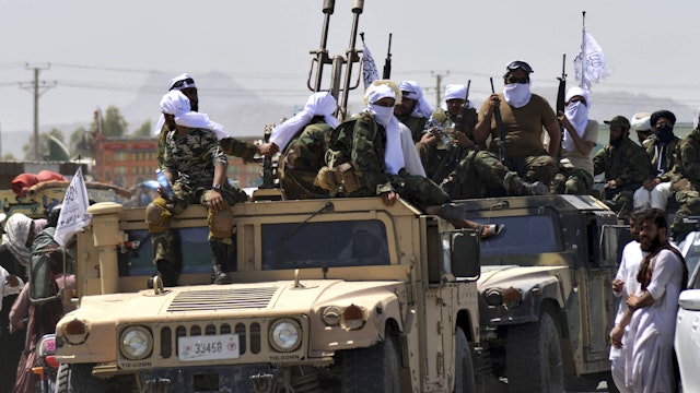 Taliban fighters atop Humvee vehicles parade along a road to celebrate after the US pulled all its troops out of Afghanistan, in Kandahar on September 1, 2021 following the Talibans military takeover of the country.