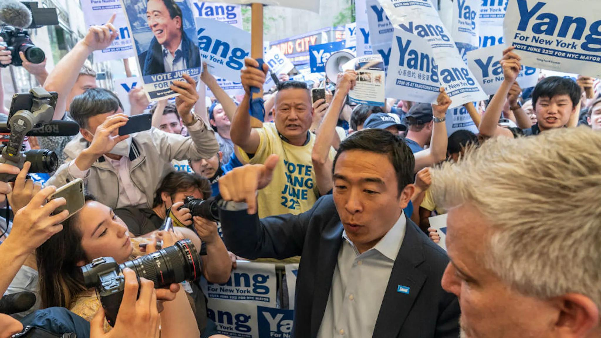 Mayoral candidate Andrew Yang arrives for debate at NBC NEW YORK, UNITED STATES - 2021/06/16: Mayoral candidate Andrew Yang arrives for debate at NBC Studios at Rockefeller Center. He greets supporters gathering outside to appreciate their support. Eight candidates according to the city electoral commission qualified for debates: Eric Adams, Kathryn Garcia, Maya Wiley, Andrew Yang, Scott Stringer, Ray McGuire, Shaun Donovan and Dianne Morales. Supporters for each candidate staged a rally outside NBC center.