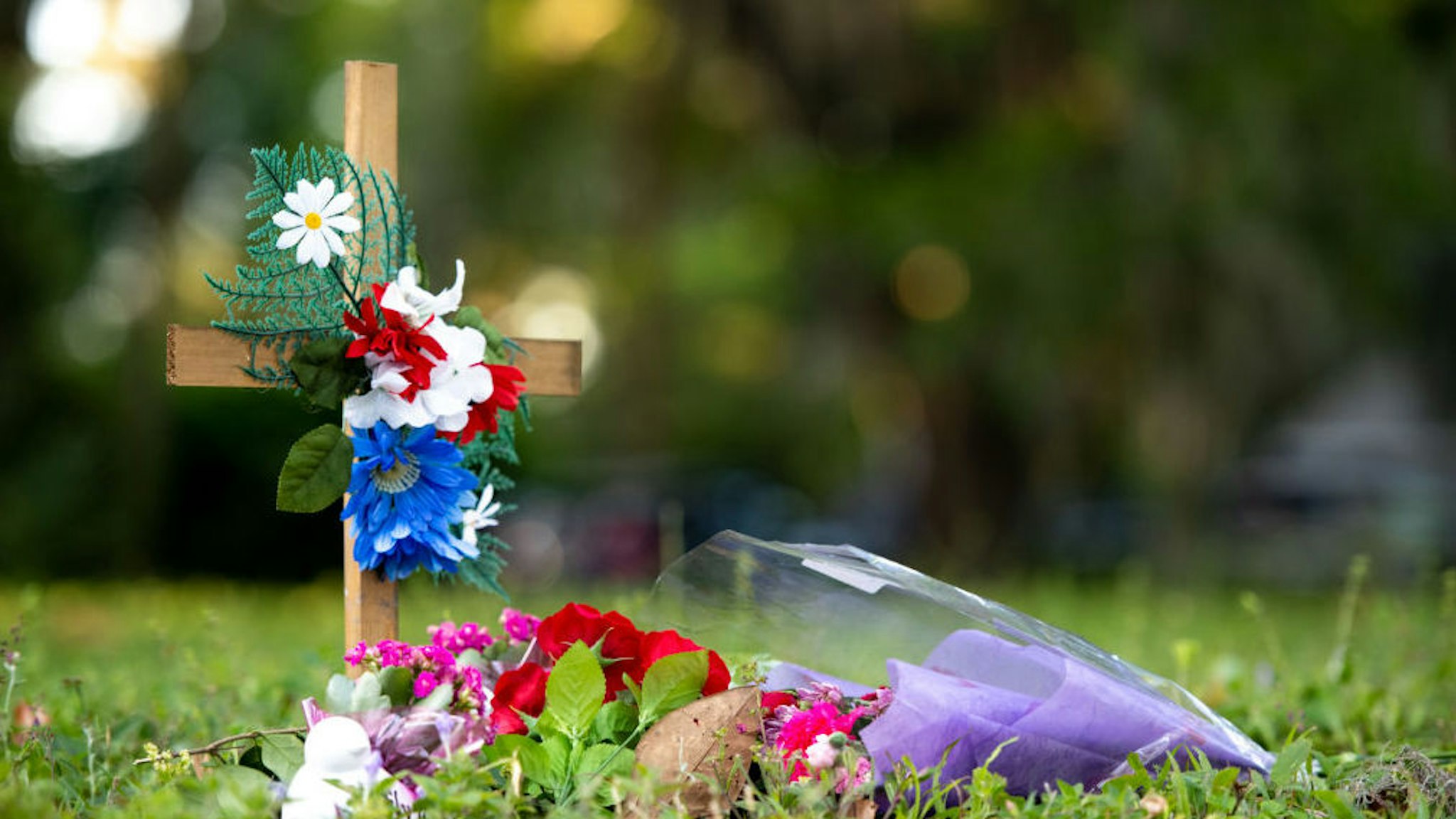 BRUNSWICK, GA - MAY 07: A cross with flowers sits near the intersection of Satilla Rd. and Holmes Rd. in the Satilla Shores neighborhood where Ahmaud Arbery was shot and killed May 7, 2020 in Brunswick, Georgia. Arbery was shot during a confrontation with an armed father and son on Feb. 23.