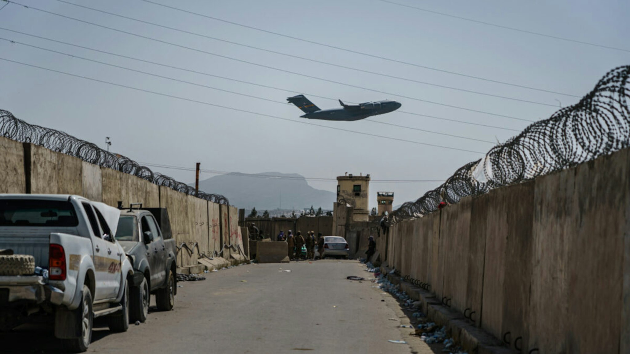 A C-17 Globemaster takes off as Taliban fighters secure the outer perimeter, alongside the American controlled side of of the Hamid Karzai International Airport in Kabul, Afghanistan, Sunday, Aug. 29, 2021.