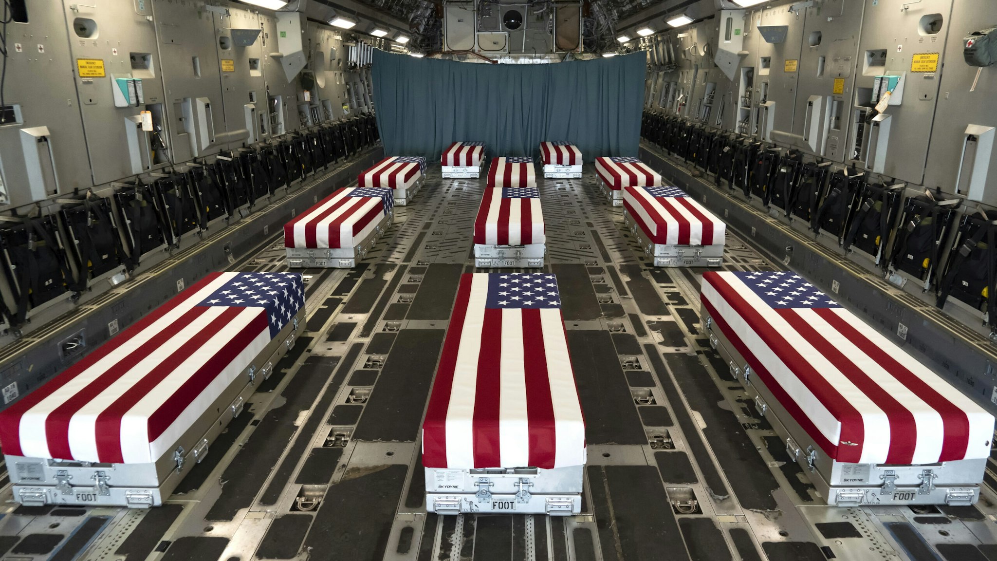 DOVER, DELAWARE - AUGUST 29: In this handout photo provided by the U.S. Air Force, flag-draped transfer cases line the inside of a C-17 Globemaster II Aug. 29, 2021, prior to a dignified transfer at Dover Air Force Base, Delaware. The fallen service members died while supporting non-combat operations in Kabul.