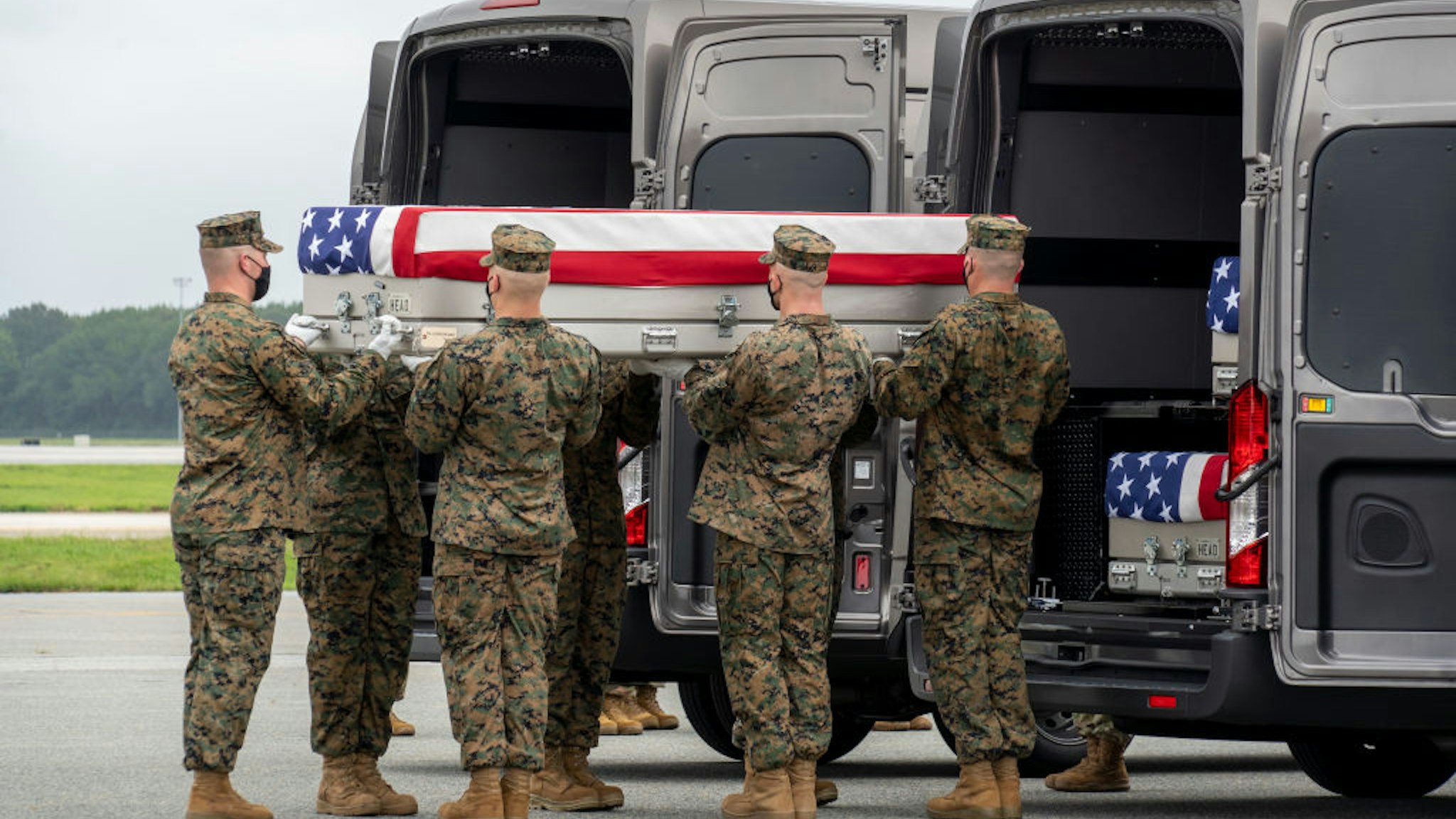 DOVER, DELAWARE - AUGUST 29: In this handout photo provided by the U.S. Air Force, a U.S. Marine Corps carry team transfers the remains of Marine Corps Lance Cpl. Kareem M. Nikoui of Norco, California, Aug. 29, 2021 at Dover Air Force Base, Delaware. Nikoui was assigned to 2nd Battalion, 1st Marine Regiment, 1st Marine Division, I Marine Expeditionary Force, Camp Pendleton, California. (Photo by Jason Minto/U.S. Air Force via Getty Images)