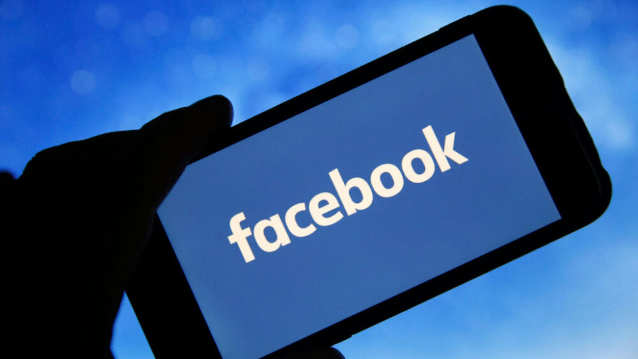 PARIS, FRANCE - JANUARY 31: In this photo illustration the Facebook logo is seen on the screen of an iPhone on January 31, 2019 in Paris, France. The social media Facebook revealed to have paid teenagers to watch their activities on their phone. The company has offered Internet users to download the application "Facebook Research" to observe all their deeds and actions, against payment. Despite this, Facebook shares soar by 11% in the wake of the announcement of a net profit up 61% to $ 6.9 billion for the last quarter of 2018.