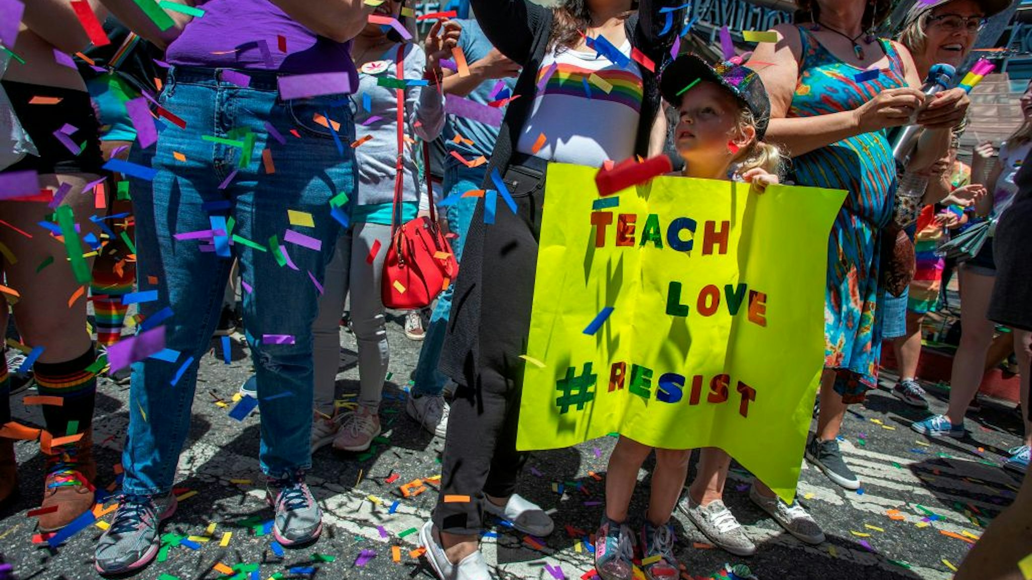 TOPSHOT - A young girl holds a sign during the annual LA Pride Parade in West Hollywood, California, on June 9, 2019. - LA Pride began on June 28, 1970, exactly one year after the historic Stonewall Rebellion in New York City, 50 years ago. (Photo by DAVID MCNEW / AFP) (Photo credit should read DAVID MCNEW/AFP via Getty Images)