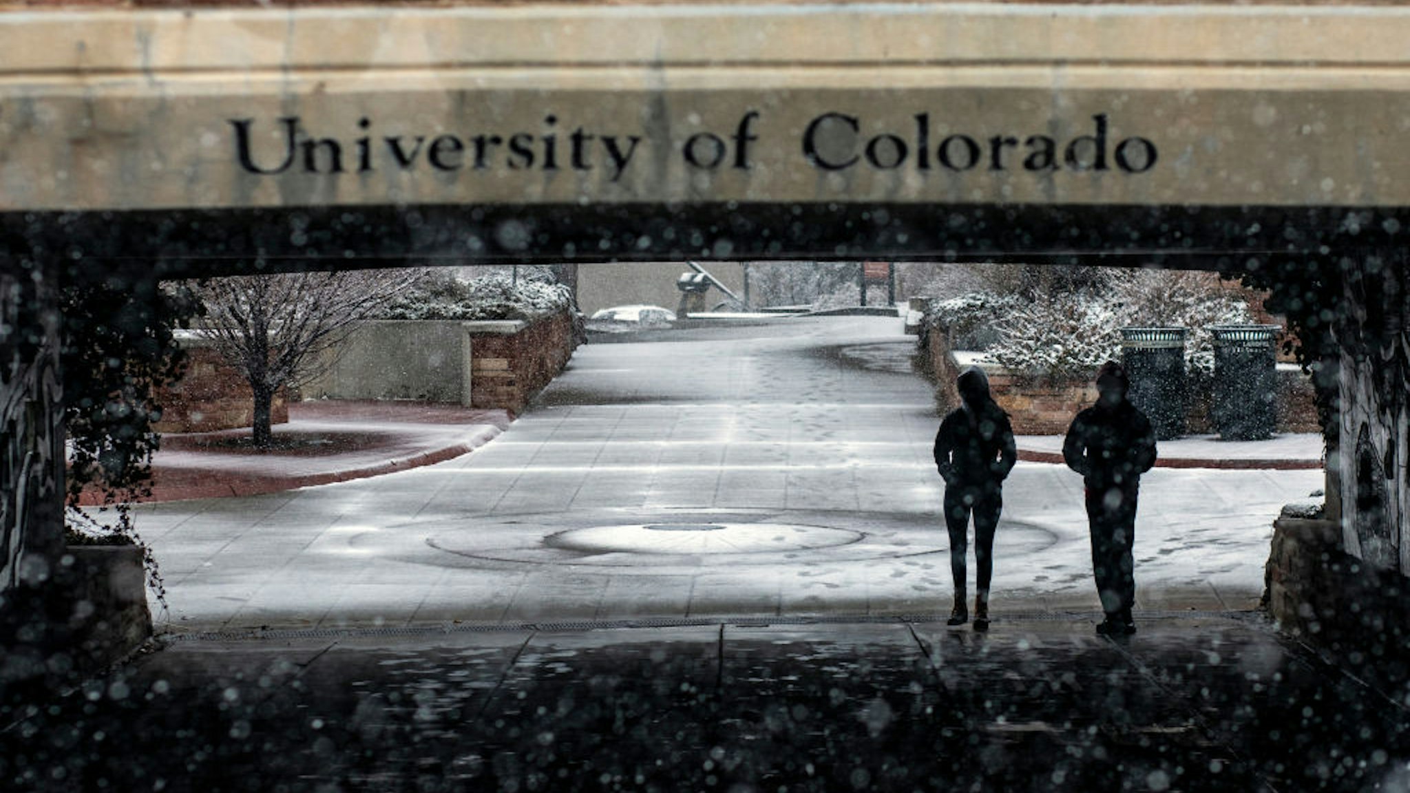Students walk through the University of Colorado Boulder campus during a winter storm in Boulder, Colorado, U.S., on Saturday, March 13, 2021.
