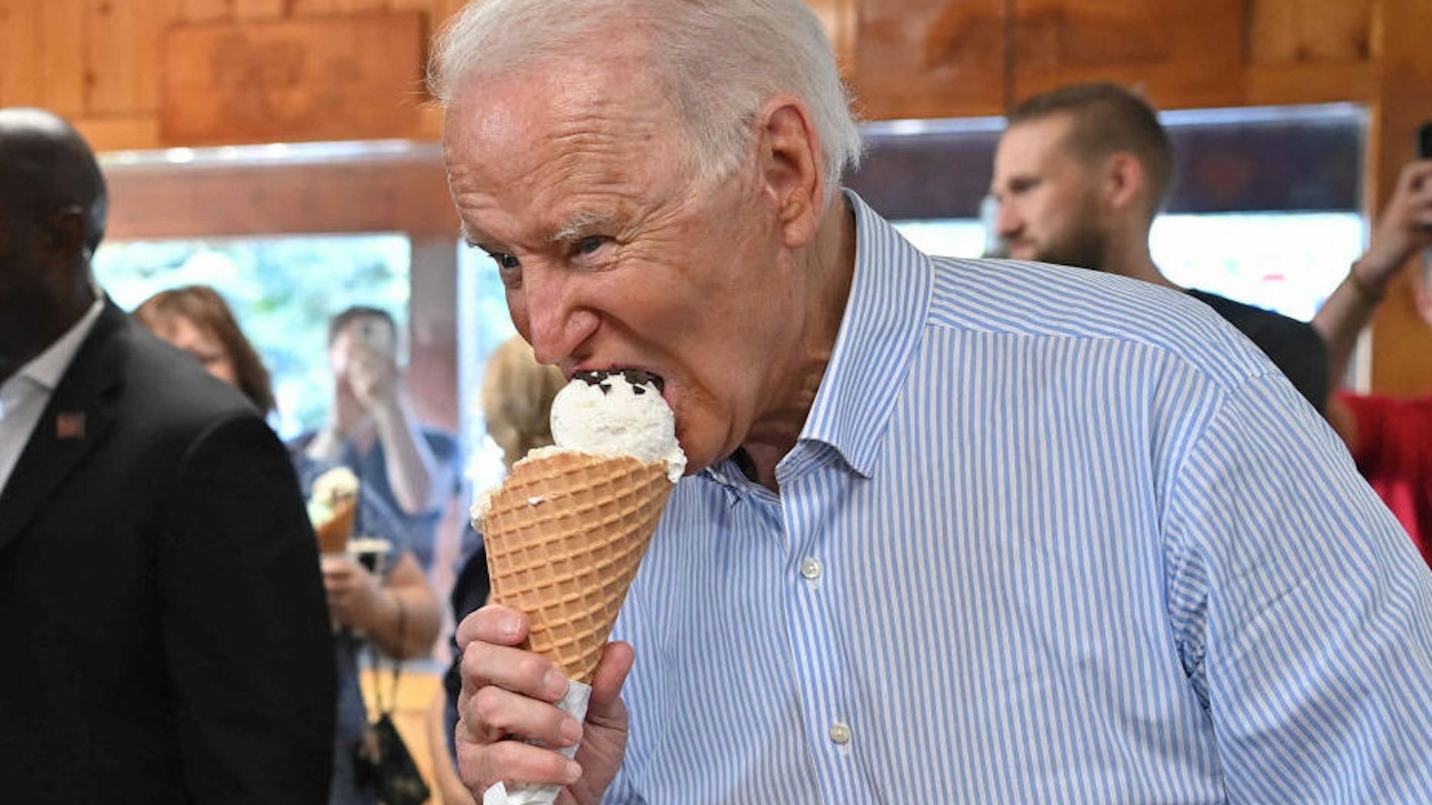 US President Joe Biden eats ice cream at Moomers Homemade Ice Cream in Traverse City, Michigan on July 3, 2021. (