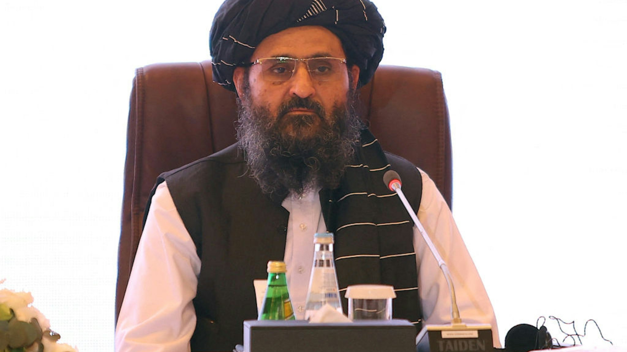 The leader of the Taliban negotiating team Mullah Abdul Ghani Baradar looks on during the final declaration of the peace talks between the Afghan government and the Taliban is presented in Qatar's capital Doha on July 18, 2021. - Representatives of the Afghan government and Taliban insurgents held talks in Doha as violence raged in their country with foreign forces almost entirely withdrawn. The two sides have been meeting on and off for months in the Qatari capital, but the talks have lost momentum as the insurgents made battlefield gains. (Photo by KARIM JAAFAR / AFP) (Photo by KARIM JAAFAR/AFP via Getty Images)