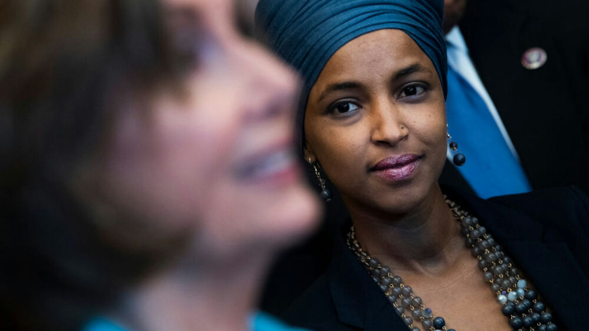 UNITED STATES - JUNE 17 (FILE): Rep. Ilhan Omar, D-Minn., right, and Speaker of the House Nancy Pelosi, D-Calif., attend a bill enrollment ceremony for the Juneteenth National Independence Day Act in the Capitol on Thursday, June 17, 2021.