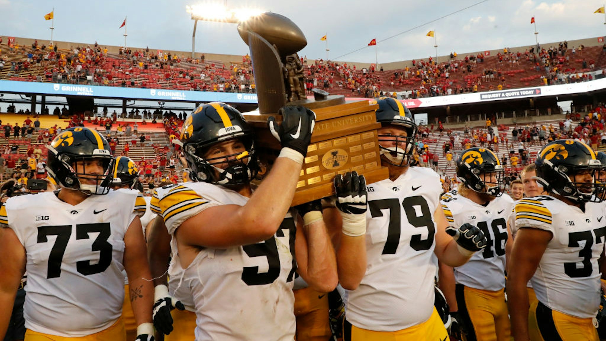 AMES, IA - SEPTEMBER 11: Defensive lineman Zach VanValkenburg #97 of the Iowa Hawkeyes and offensive lineman Jack Plumb #79 of the Iowa Hawkeyes carry the Cy-Hawk Trophy off the field after defeating the Iowa State Cyclones 27-17 at Jack Trice Stadium on September 11, 2021 in Ames, Iowa. The Iowa Hawkeyes won 27-17 over the Iowa State Cyclones. (Photo by David Purdy/Getty Images)