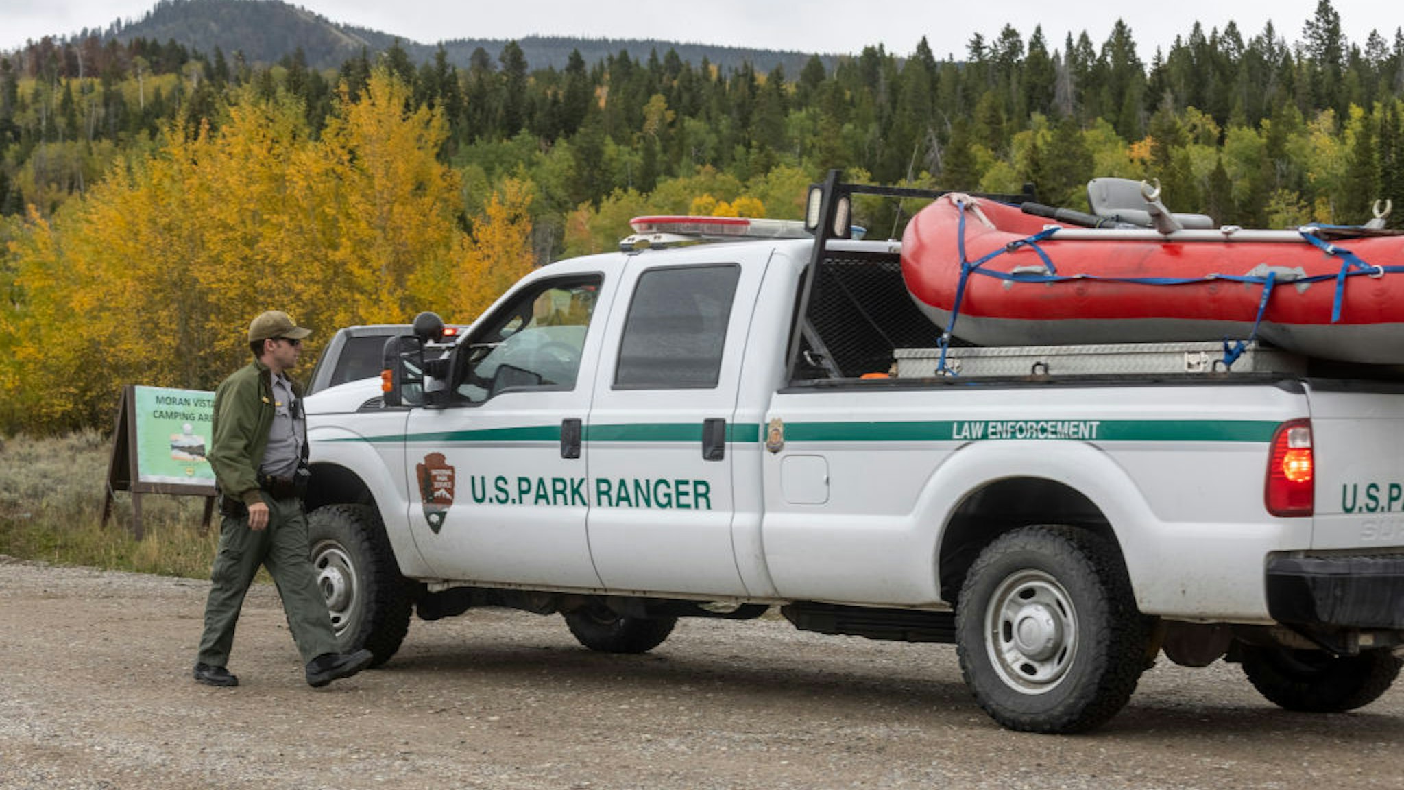 A park ranger speaks with a colleague on the road to Spread Creek Campground on September 19, 2021 near Moran, Wyoming.