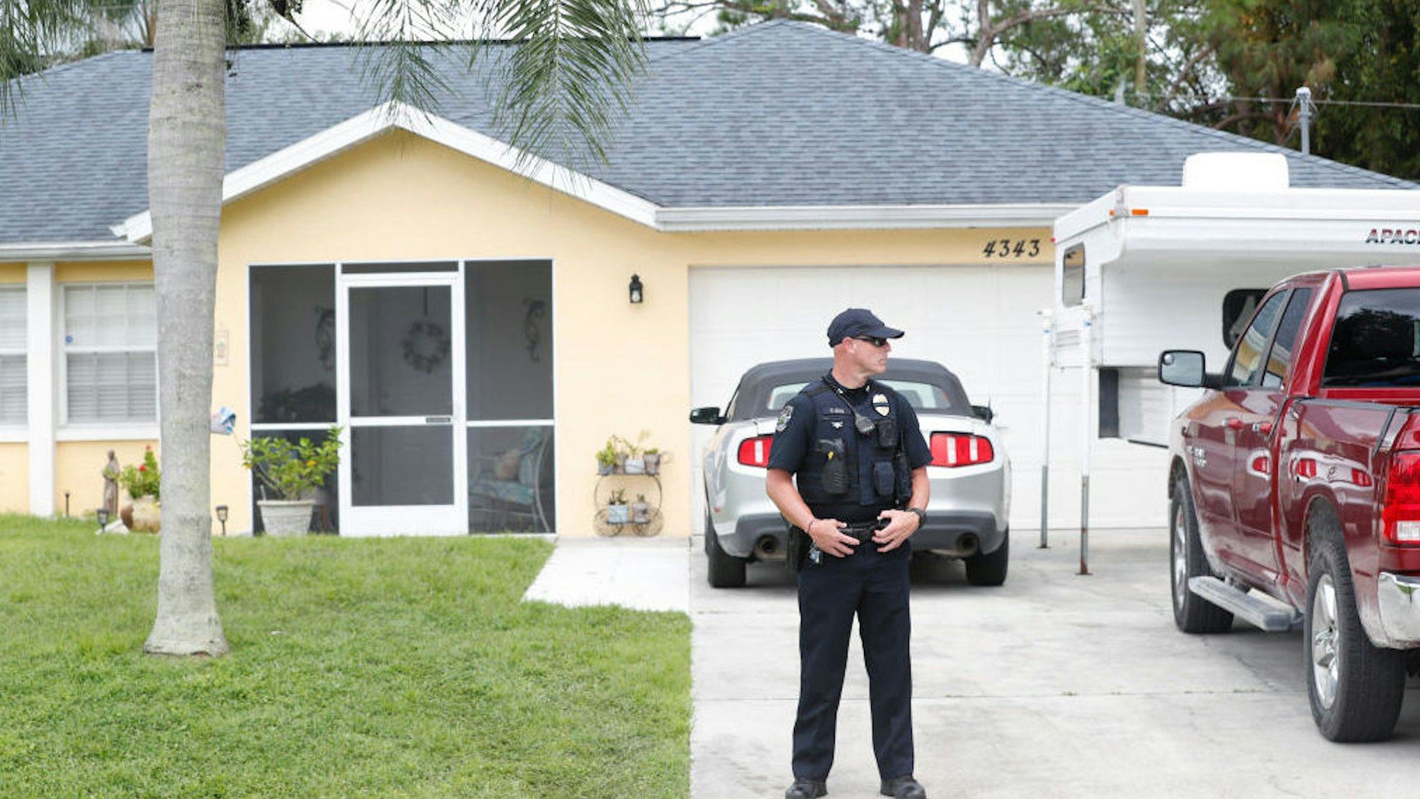 A North Port Police officer stands in the driveway of the family home of Brian Laundrie, who is a person of interest after his fiancé Gabby Petito went missing on September 20, 2021 in North Port, Florida.