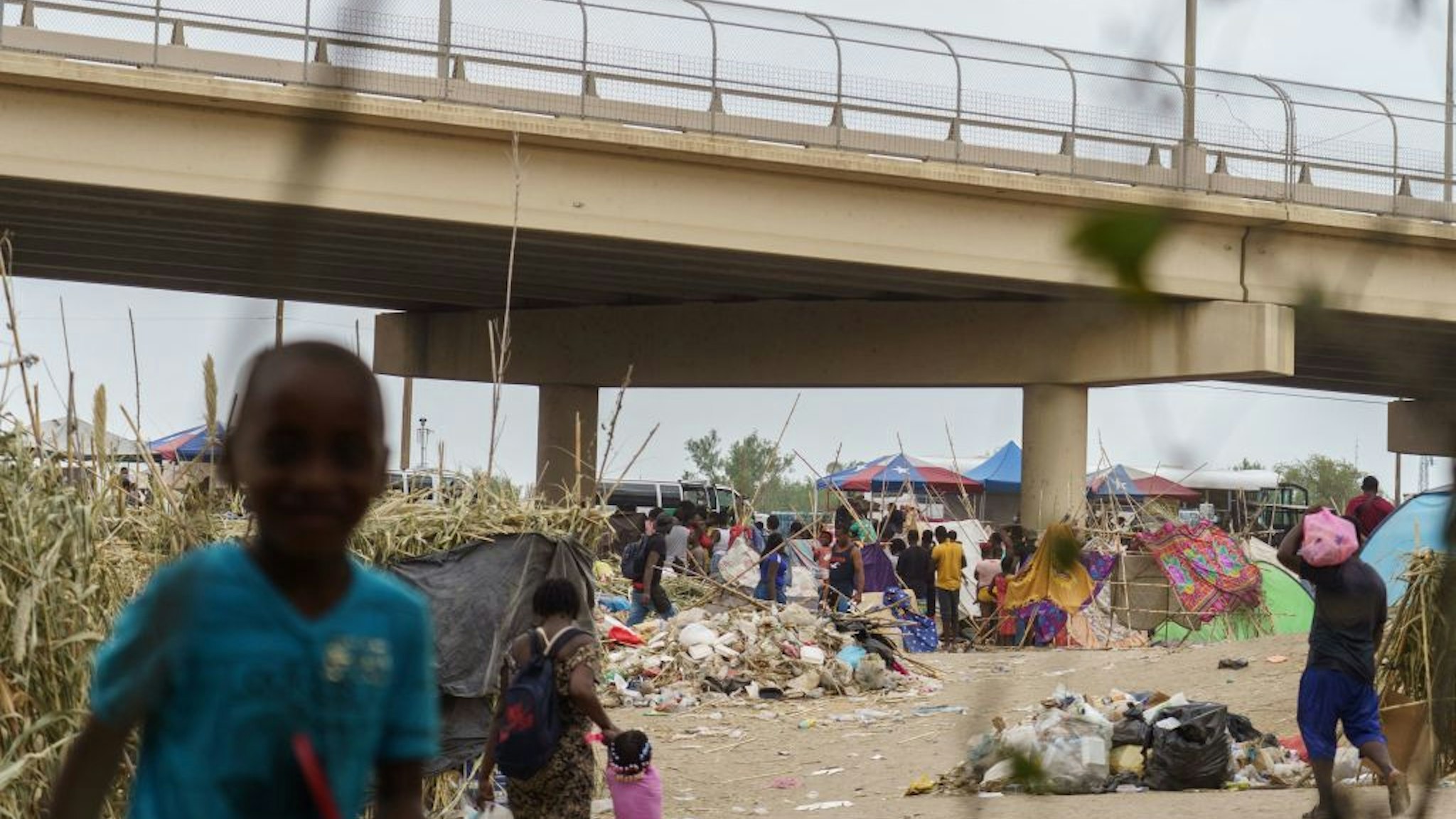 Haitian migrants are pictured in a makeshift encampment where more than 12,000 people hoping to enter the United States await under the international bridge in Del Rio, Texas on September 21, 2021.