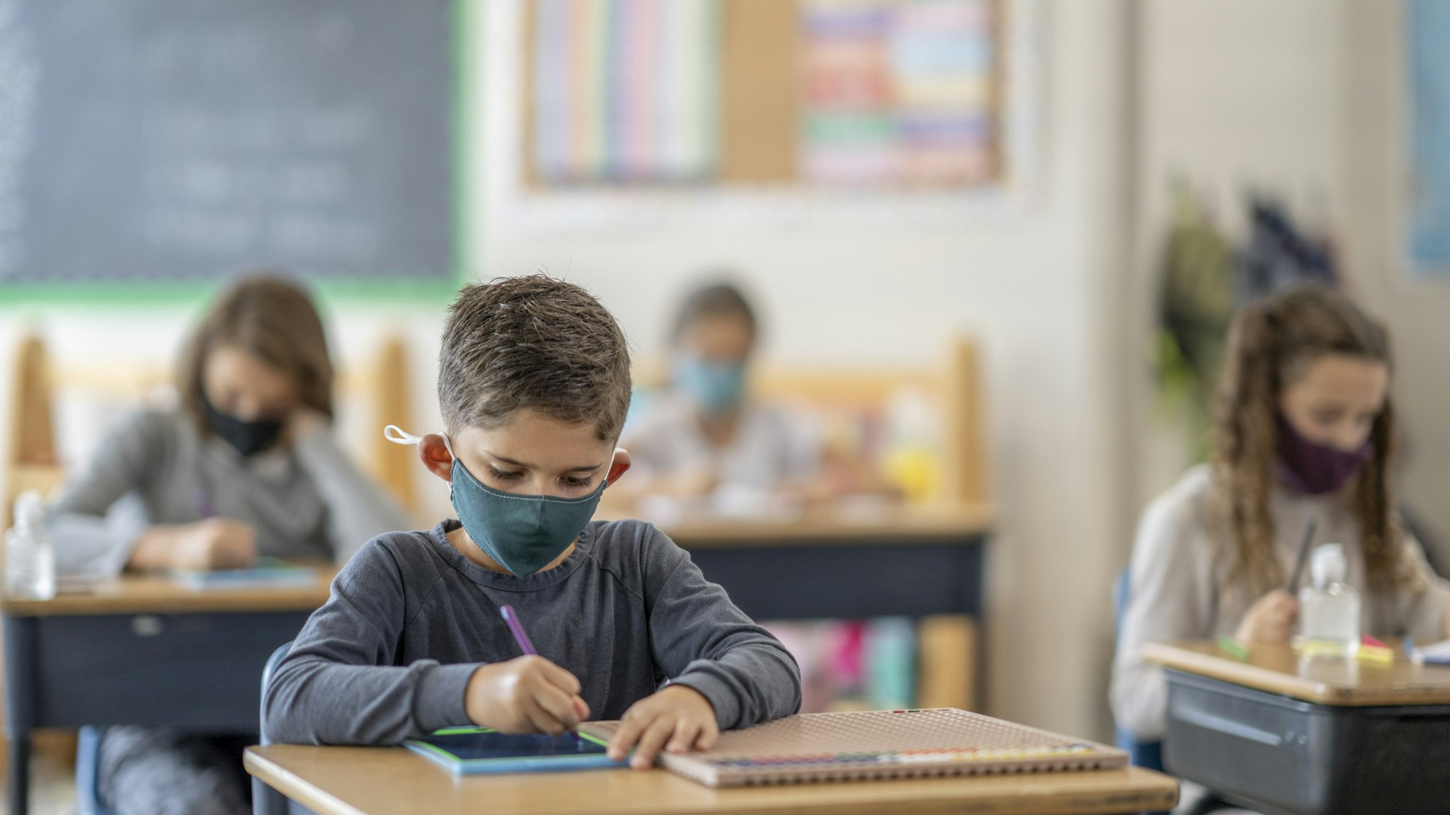 Students wearing masks in class - stock photo
