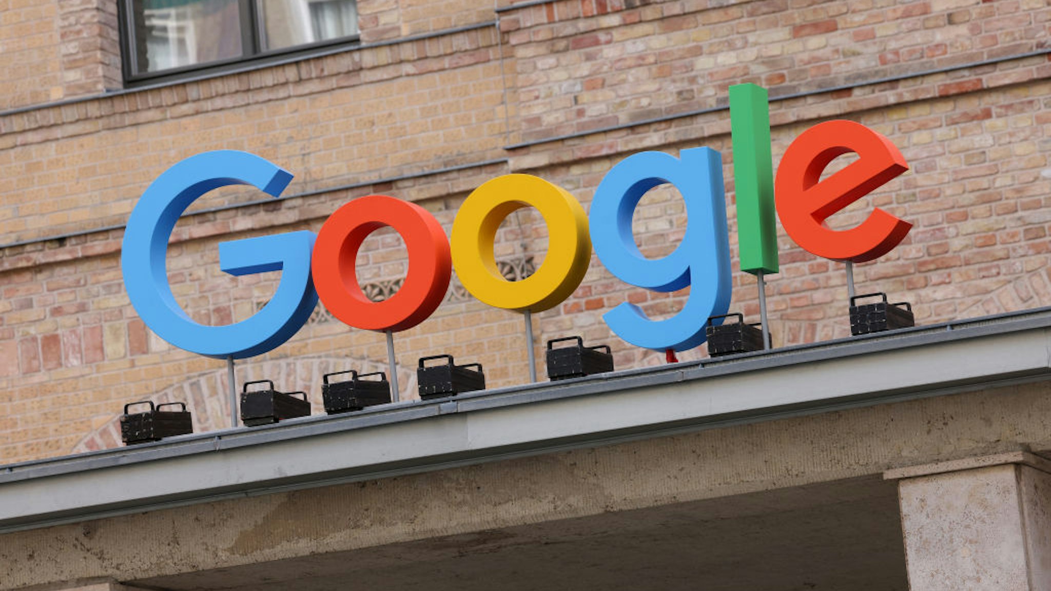 The Google corporate logo hangs outside the Google Germany offices on August 31, 2021 in Berlin, Germany.