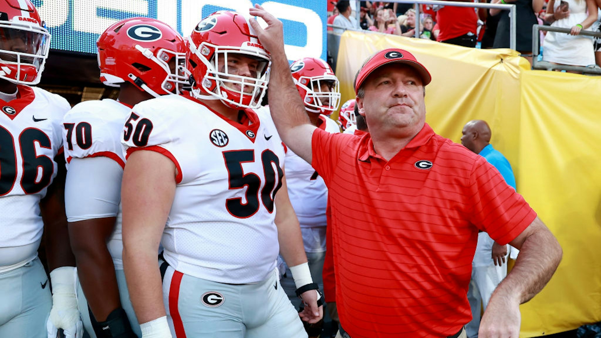 CHARLOTTE, NORTH CAROLINA - SEPTEMBER 04: Head coach Kirby Smart of the Georgia Bulldogs leads his team onto the field before their game against the Clemson Tigers in the Duke's Mayo Classic at Bank of America Stadium on September 04, 2021 in Charlotte, North Carolina. (Photo by Grant Halverson/Getty Images)