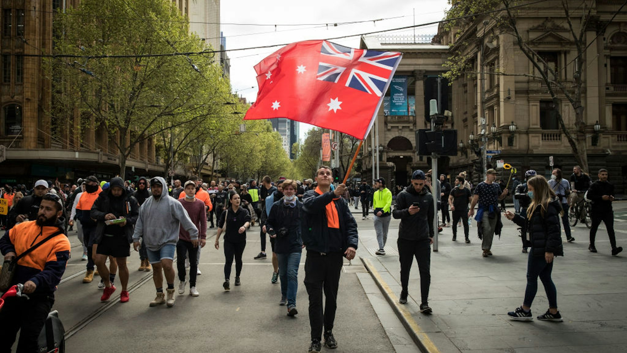 Protesters march through the streets on September 22, 2021 in Melbourne, Australia.