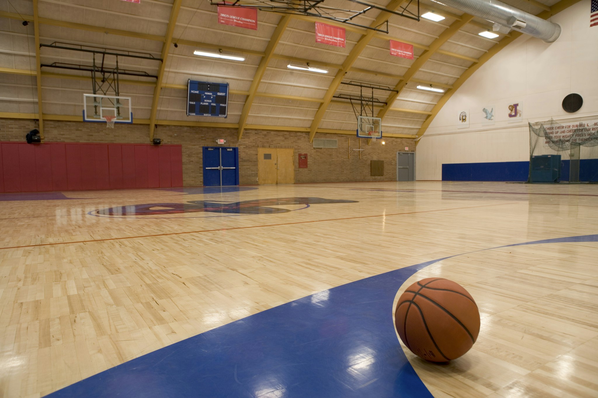 Basketball on gym floor - stock photo