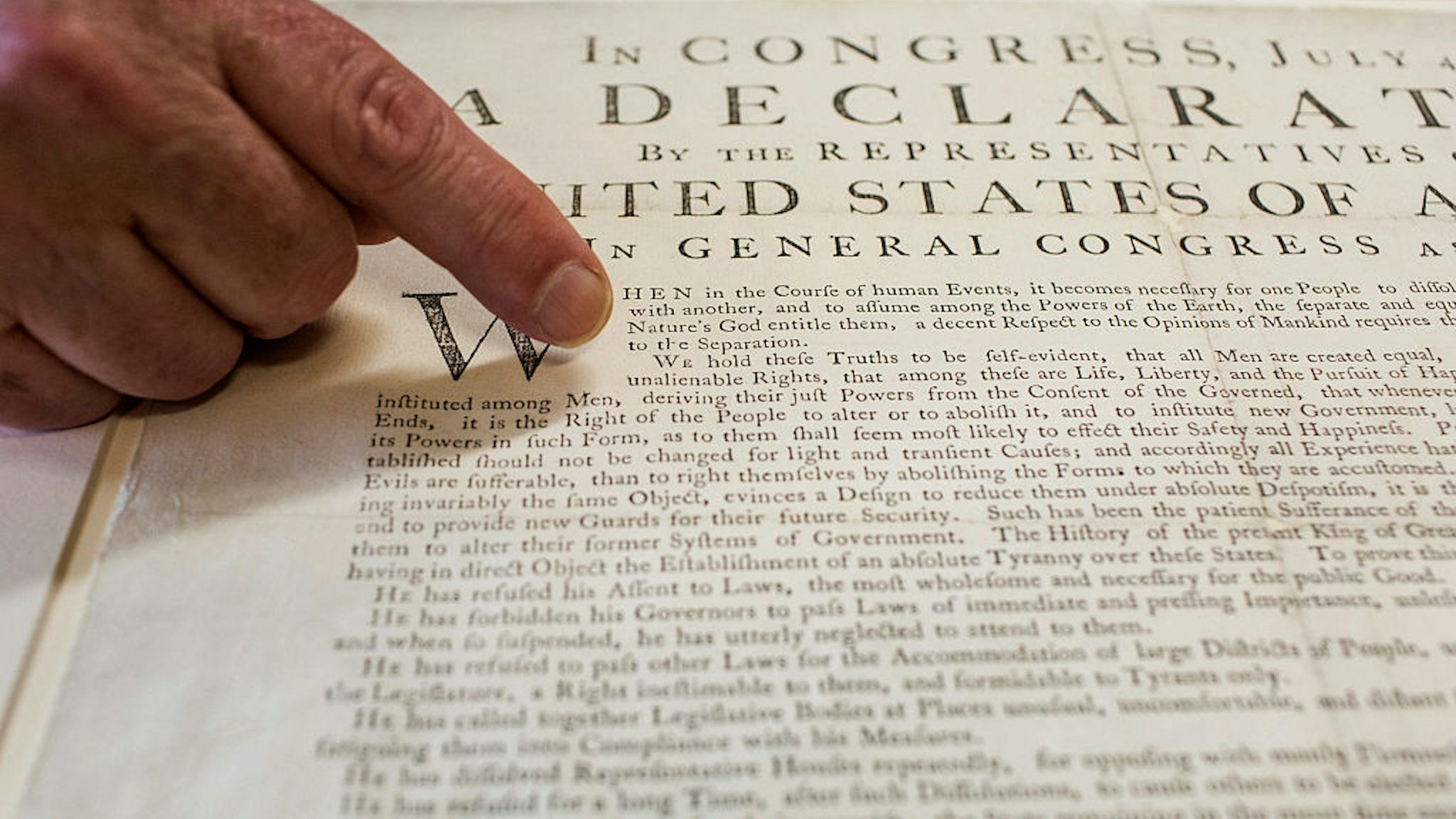 Peter Drummey, chief reference librarian of the Massachusetts Historical Society, points to a rare copy of the Declaration of Independence, known as a "Dunlap Broadside," at the society in Boston, Massachusetts, U.S., on Monday, June 29, 2015. Here in acid-free, low humidity stacks are 13 million pages of the personal letters and diaries of men and women who helped create the world we live in. Photographer: Shiho Fukada/Bloomberg via Getty Images