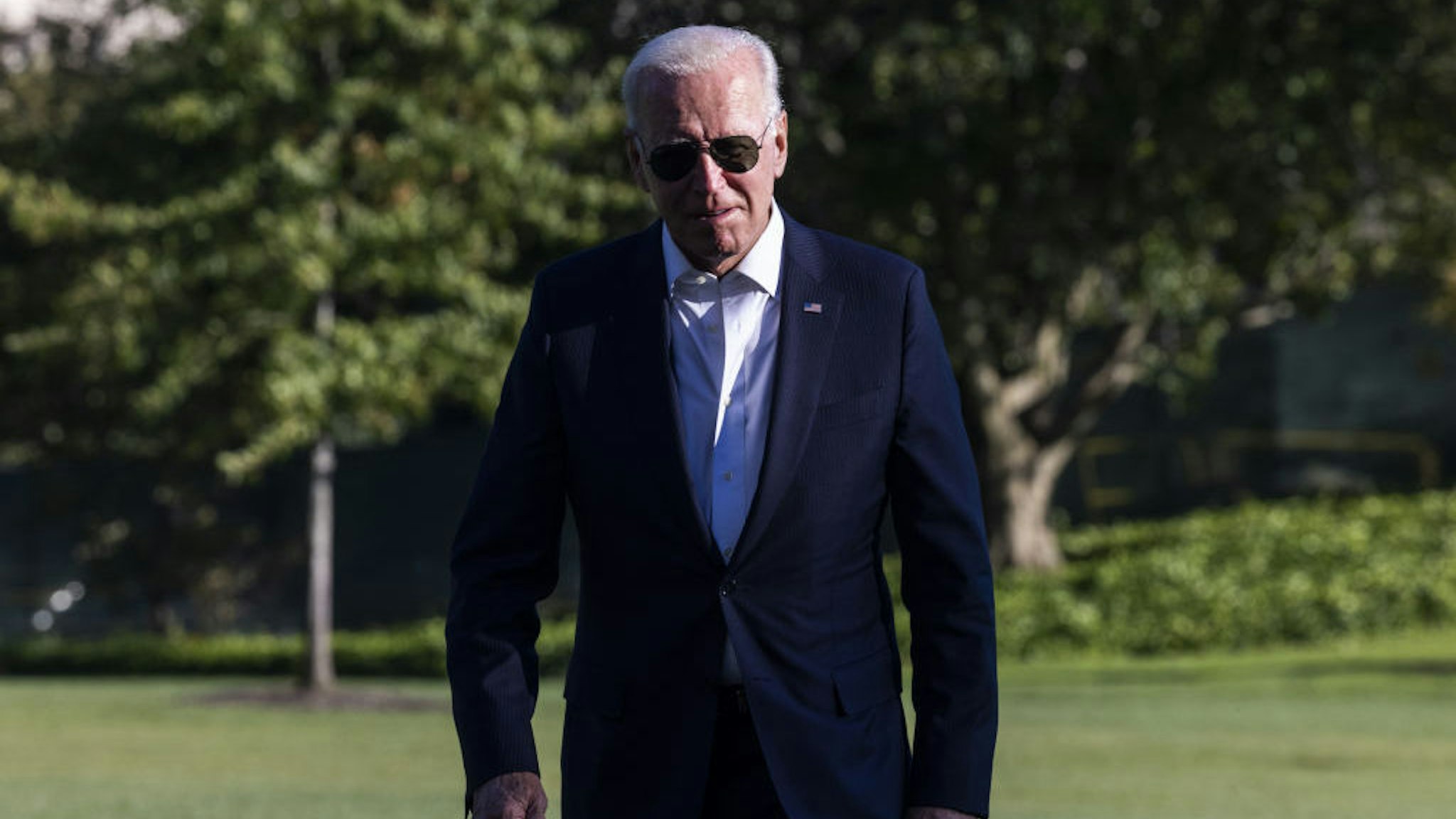 U.S. President Joe Biden walks on the South Lawn of the White House after arriving on Marine One in Washington, D.C., U.S., on Sunday, Sept. 26, 2021. The House Budget Committee advanced a draft version of Biden's signature tax and social spending measure, a milestone ahead of possible votes on the floor of the chamber next week. Photographer: Jim Lo Scalzo/EPA/Bloomberg