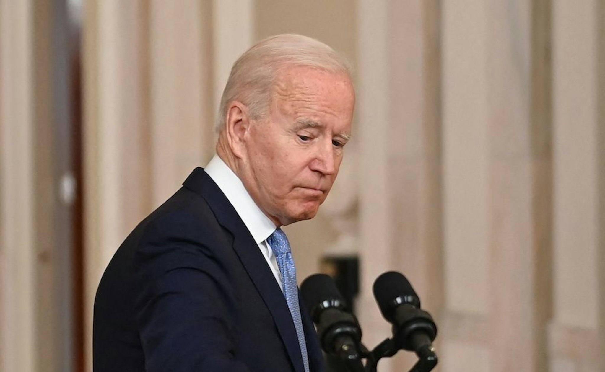 US President Joe Biden looks back after speaking on ending the war in Afghanistan in the State Dining Room at the White House in Washington, DC, on August 31, 2021. - US President Joe Biden is addressing the nation on the US exit from Afghanistan after a failed 20 year war that he'd vowed to end but whose chaotic last days are now overshadowing his presidency. (Photo by Brendan SMIALOWSKI / AFP) (Photo by BRENDAN SMIALOWSKI/AFP via Getty Images)