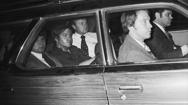 4/10/81-Washington, DC: John Hinckley, Jr. (center), the man charged with the attempted murder of President Reagan, now finds himself the center of Federal protection, March 30th, as he is driven away from U.S. District Court. Hinckley was seated in the center seat of a nine-seat section station with agents assigned to protect him, seated in front, alongside, and behind him. Ph: John Full
