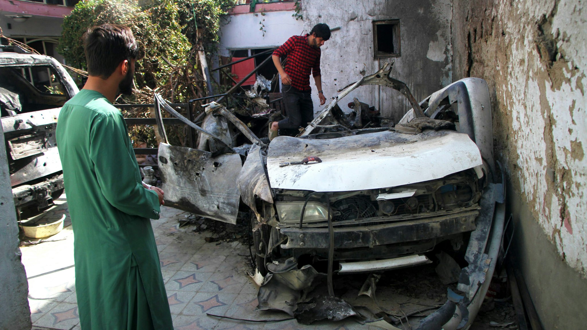 Photo taken on Sept. 2, 2021 shows damaged vehicles at the site of the U.S. airstrike in Kabul, capital of Afghanistan. TO GO WITH: "Feature: Neighbor, relative of drone strike victims lambaste U.S. killing in Afghanistan.
