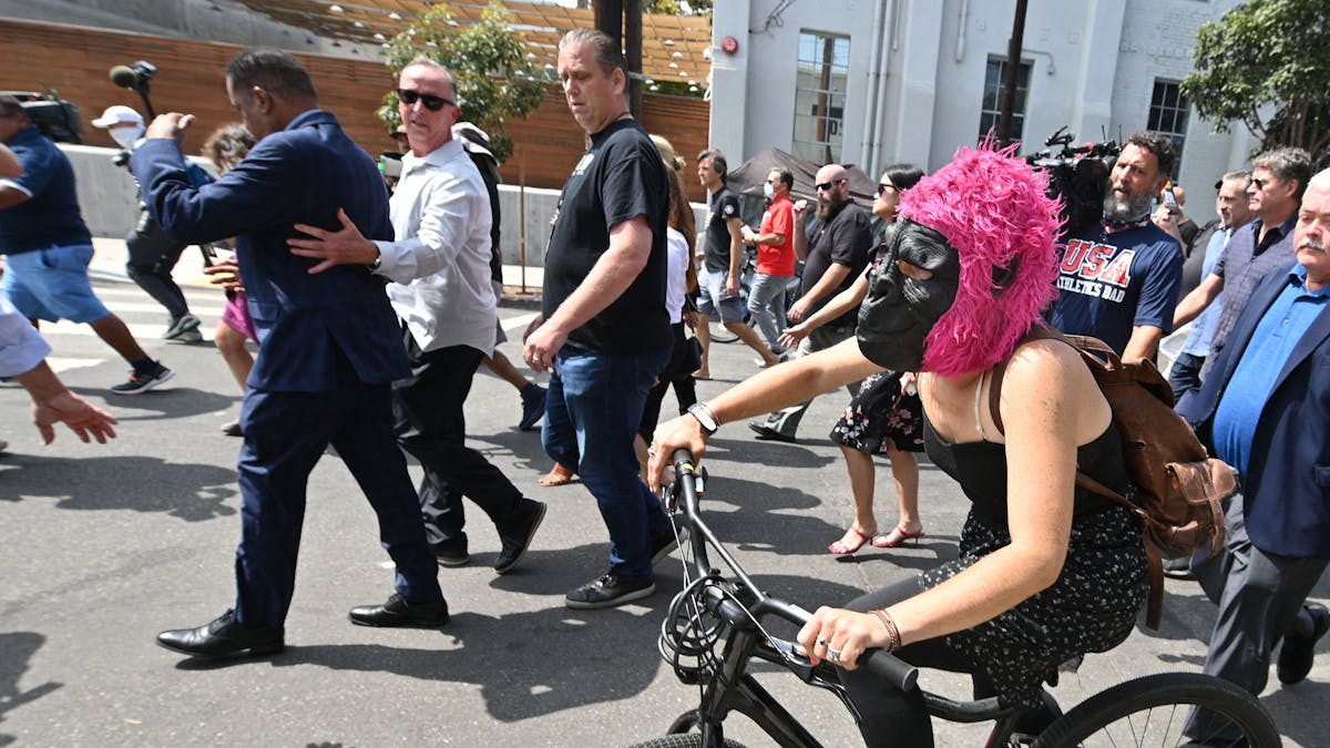 WATCH: White Woman Wearing Monkey Mask Throws Egg At Larry Elder