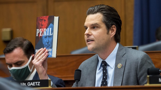 WASHINGTON, DC - SEPTEMBER 29: Rep. Matt Gaetz (R-FL) holds up a copy of the book Peril during a House Armed Services Committee hearing on Ending the U.S. Military Mission in Afghanistan in the Rayburn House Office Building at the U.S. Capitol on September 29, 2021 in Washington, DC.