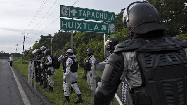 Members of The National Guard block a street during an operation to dissolve a caravan of Central American and Haitian migrants heading to the US, in Huixtla, Chiapas state, Mexico, on September 5, 2021.