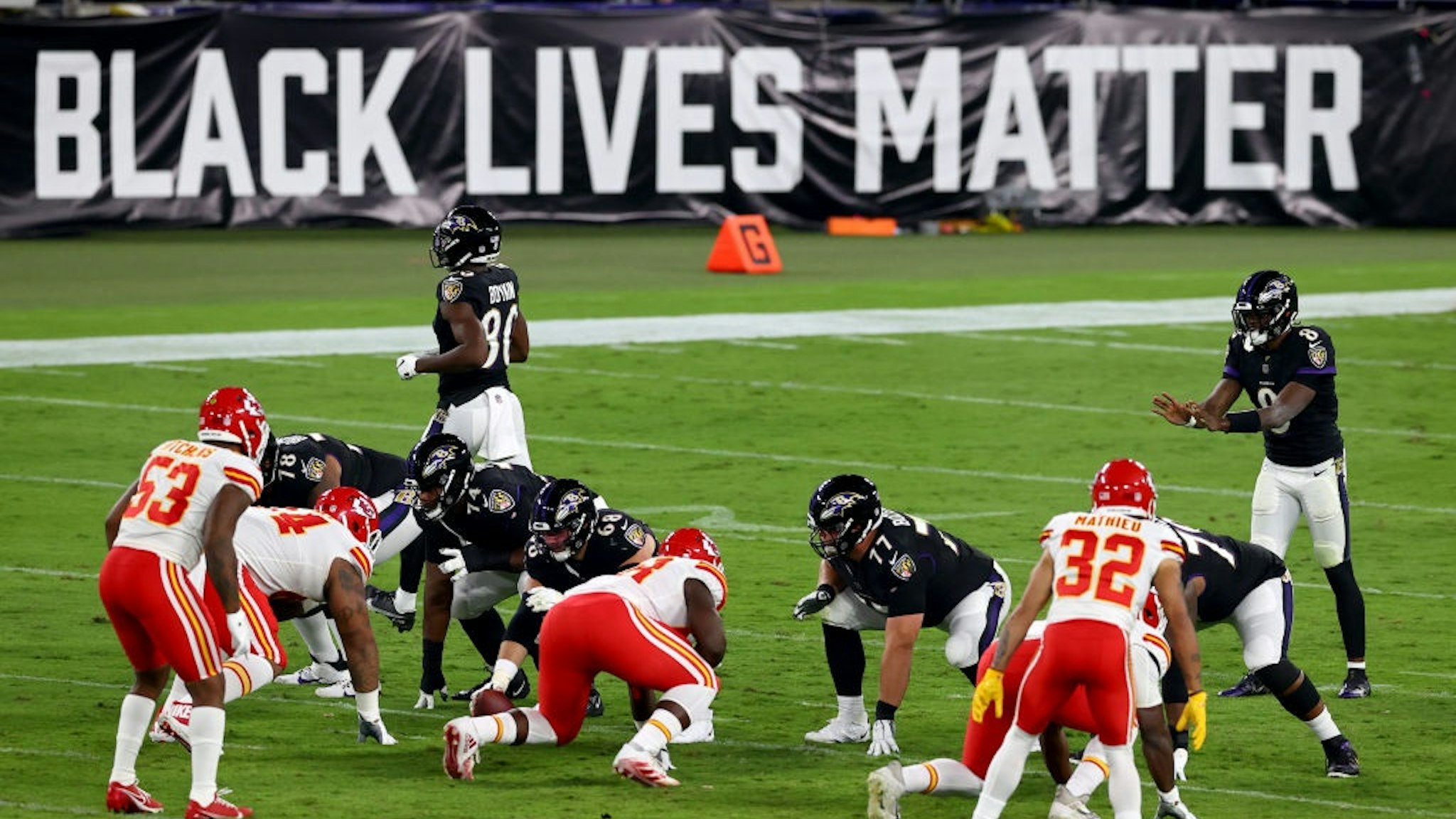 BALTIMORE, MARYLAND - SEPTEMBER 28: Lamar Jackson #8 of the Baltimore Ravens waits for the snap in front a sign that reads "Black Lives Matter" against the Kansas City Chiefs on September 28, 2020.
