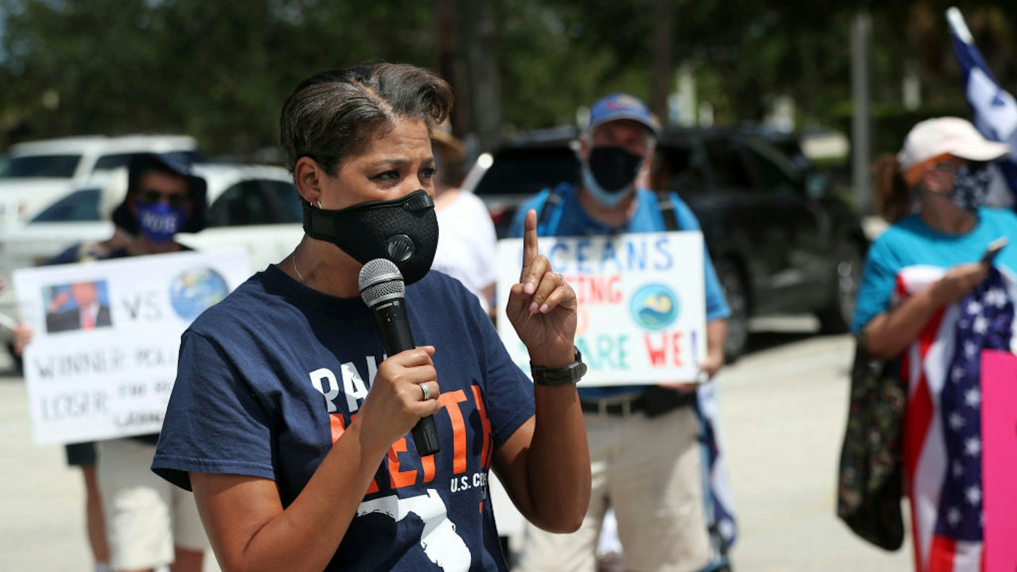 Congressional candidate Pam Keith, who is running against Rep. Brian Mast, speaks to anti-Trump protesters at Burt Reynolds Park in Jupiter, Florida on Tuesday, Sept. 8, 2020. President Donald Trump made an appearance at the Jupiter Inlet Lighthouse touting his environmental policies and announcing he's extending the moratorium on offshore oil drilling in Florida.
