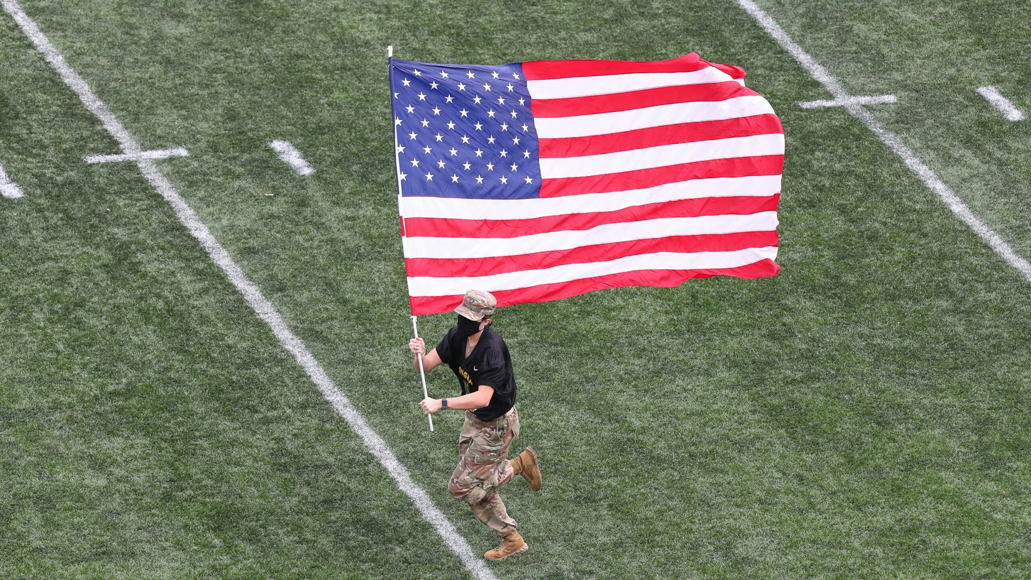 WEST POINT, NY - NOVEMBER 21: An Army Cadet carries the American Flag on the filed prior to the game against the Georgia Southern Eagles at Michie Stadium on November 21, 2020 in West Point, New York.
