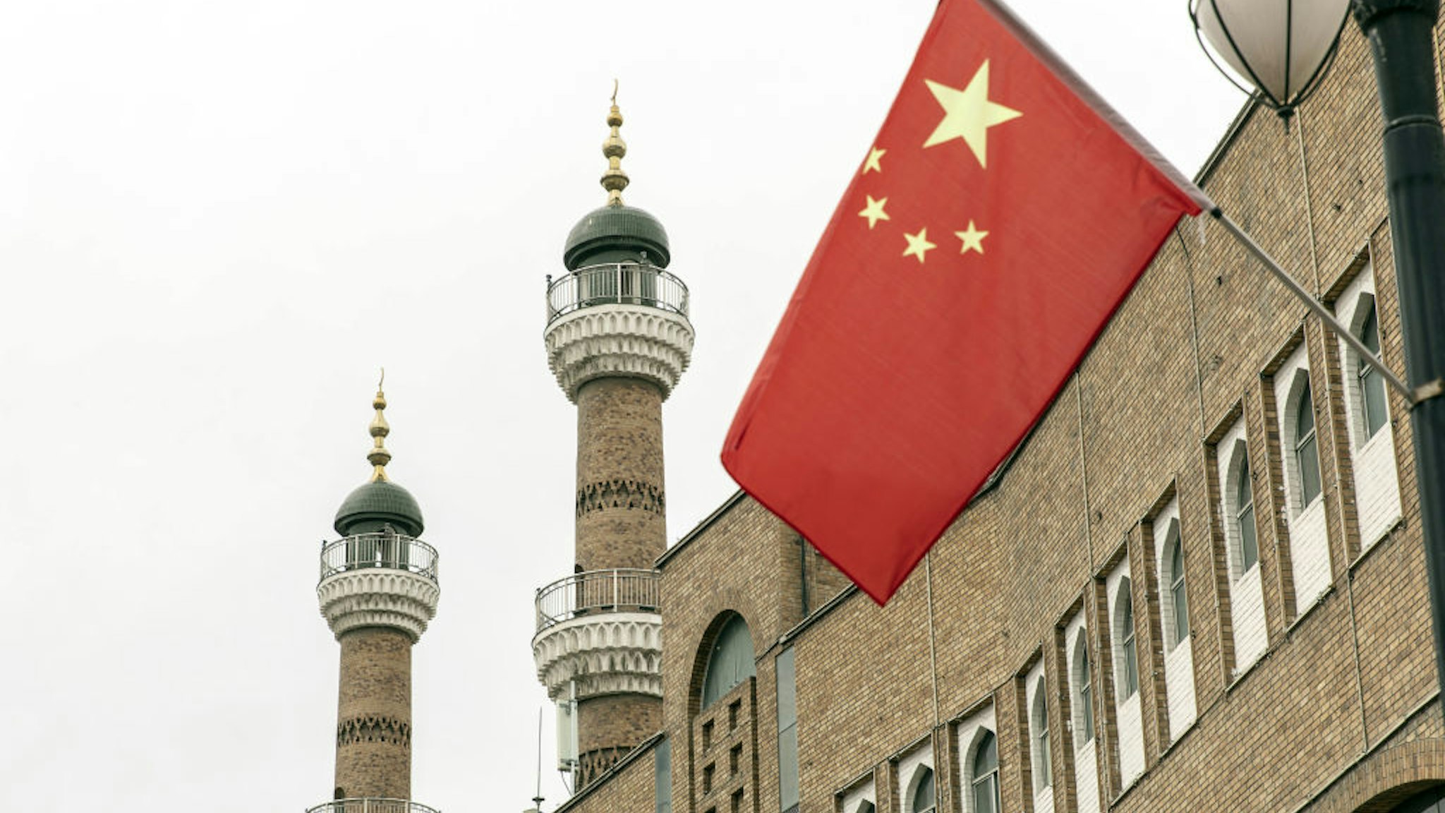 A Chinese national flag outside the Xinjiang International Grand Bazaar in Urumqi, Xinjiang province, China, on Wednesday, May 12, 2021. China has told nations criticizing its policies in Xinjiang to stop interfering in domestic affairs.