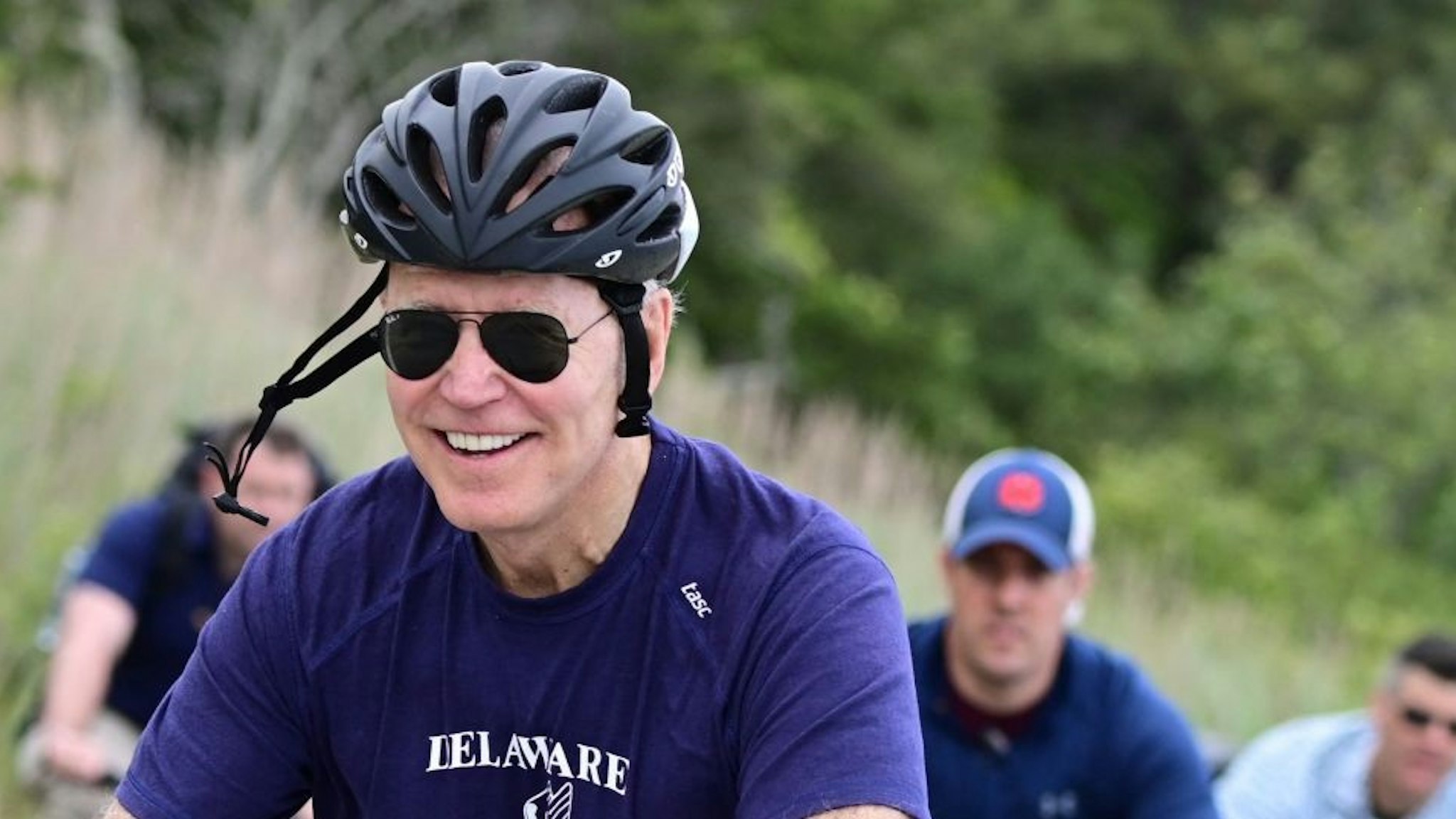 TOPSHOT - US President Joe Biden rides his bicycle in Cape Henlopen State Park on June 3, 2021, in Lewes, Delaware. (Photo by JIM WATSON / AFP) (Photo by